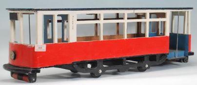 A large vintage 20th Century scratch built model of a tram with painted features.  Measures 24 cm