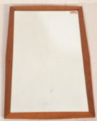 A retro mid 20th Century teak framed wall hanging mirror of rectangular form having arched top and