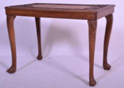 A 20th Century carved wood low occasional table having an intricately carved table top, decorated