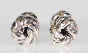 A pair of sterling silver mens cufflinks. The cufflinks take the form of a simple circular knot