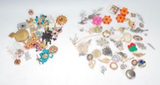 A collection of vintage mid 20th Century brooches to include a Scottish Grouse claw brooch, floral