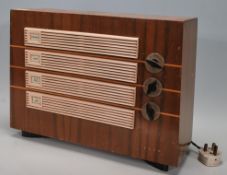A vintage mid 20th Century walnut cased Ecko radio having cream bakelite cover to the front with