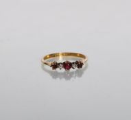 A stamped 18ct gold ladies 1920's/30's ring set with three round cut rubies and two diamonds. Weight