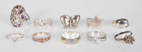 A collection of silver rings including 925 silver ring with butterfly design, a .925 silver with