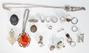A collection of vintage and antique jewellery to include a carved black stone cameo brooch, a