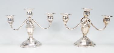 A pair of 20th century sterling silver three sconce candelabra. Marked to the base for Revere