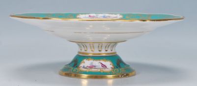 A 19th Century French style centrepiece tazza having a green ground with panels of hand painted