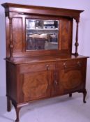 An Edwardian mahogany mirror back sideboard raised on shaped legs with a wide base with short