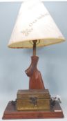 An unusual 20th century table lamp formed from the stock of a rifle / shotgun complete with shade
