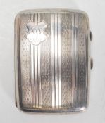 An early 20th Century Art Deco English silver hallmarked cigarette case of rectangular bowed form
