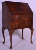 A Queen Ann style 20th Century mahogany bureau raised on cabriol legs with carved shell