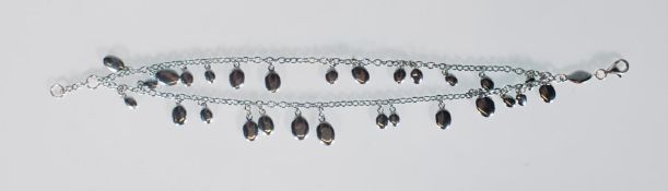 A stamped 925 silver Kit Heath charm bracelet with a double chain polished coast pebble design.
