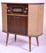 A retro mid 20th Century Argosy Consolette radiogram of slender walnut veneered construction. Twin