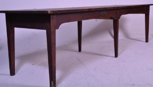 A very large early 20th century country house refectory dining table being raised on 6 legs of