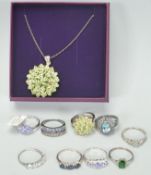 A selection of nine ladies silver dress rings to include a green stone cluster ring together with
