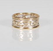 A stamped 375 9ct gold two tone ring having a pierced decoration celtic knot design in white gold