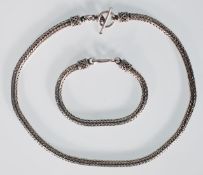 A gentleman's silver large snake chain necklace having a toggle clasp together with a matching