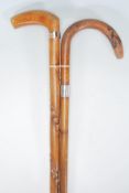 A pair of 20th century wooden walking sticks havin