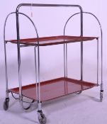 A retro mid 20th Century chrome and wooden trolley by Gerlinol Brenshey Dinett. Raised on original