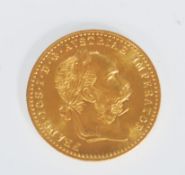 An 18ct gold Austrian 1 Ducat coin (restrike) having a head facing right and coat of arms to the