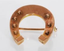 A 19th Century Victorian equestrian related horse shoe brooch having raised detailing, with a