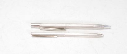 Two silver hallmarked pens having engine turned decoration #, one having a twist mechanism and the