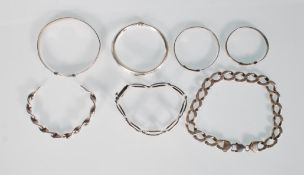 A collection of silver bracelets including a 925 silver chain bracelet, a 925 silver bracelet of