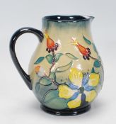 A Moorcroft jug of bulbous form in the Hypericum pattern, designed by Rachel Bishop. The jug with