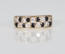 A 9ct gold ladies dress ring having two rows of alternate round cut sapphires and diamonds. Marked
