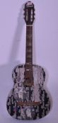A vintage Dulcet spanish six string acoustic guitar, the body decorated with Dead Million stickers