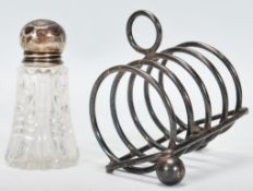 A silver hallmarked four slice toast rack, raised on finial feet (two missing), Birmingham assay,