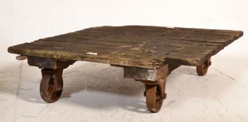 A 19th century Industrial cast iron and wooden dram trolley / factory trolley. Raised on cast iron