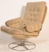 A 20th Century retro vintage swivel lounge chair / armchair having tubular chromed metal