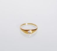 An 18ct gold ring set with a rectangular cut white stone. Unmarked but tests as 18ct gold. Weight