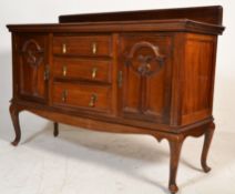 An Edwardian mahogany geometric block fronted sideboard / dresser base being raised on cabriole legs