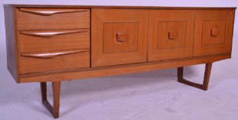 A retro Danish influenced mid century teak wood sideboard credenza  being raised on angled legs with