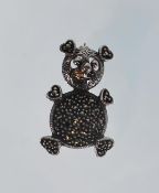 A ladies silver brooch in the shape of a teddy bear. The brooch is set with marcasites and