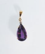 A 20th century 18ct gold pendant set with a tear drop cut amethyst and a round cut diamond above.