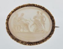 A late 19th / early 20th Century cameo brooch of oval form set with a conch shell panel decorated
