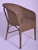 A vintage early to mid 20th Century Lloyd Loom conservatory / garden wicker style armchair, having a