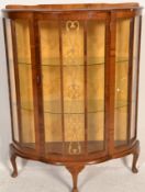 An early 20th Century 1930's Art Deco walnut demi lune display cabinet being raised on cabriole legs