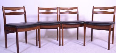 A matching set of four retro mid 20th Century twin rail back dining chairs having black vinyl seat