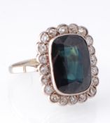 A French 18ct gold Sapphire and diamond cluster ring. The ring set with a rectangular mixed cut