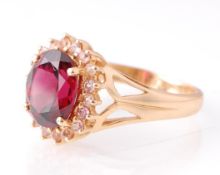 14CT YELLOW GOLD LARGE OVAL CUT RED STONE AND DIAMOND RING
