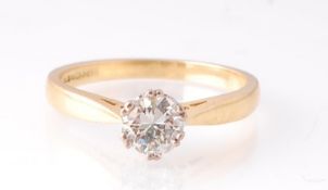 A hallmarked 18ct yellow gold diamond solitaire ring. The ring being set with a round cut diamond