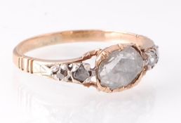 A Georgian gold and diamond 5 stone ring. The set with a large central rose cut diamond flanked by