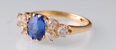 An 18ct gold sapphire and diamond ring. The ring set with an oval mixed cut sapphire - believed