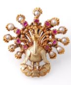 A 19th century figural gold pearl and ruby brooch pin in the form of a bird. The brooch in the