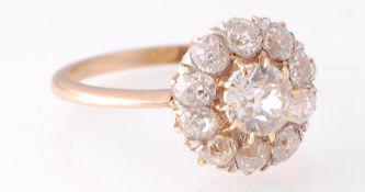 An early 20th century 15ct gold and diamond cluster ring. The ring set with a round brilliant cut