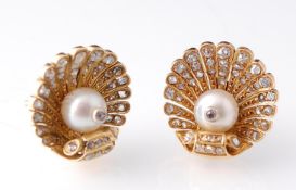 A pair of Art Deco diamond and pearl shell earrings. The earrings in the form of clam shells